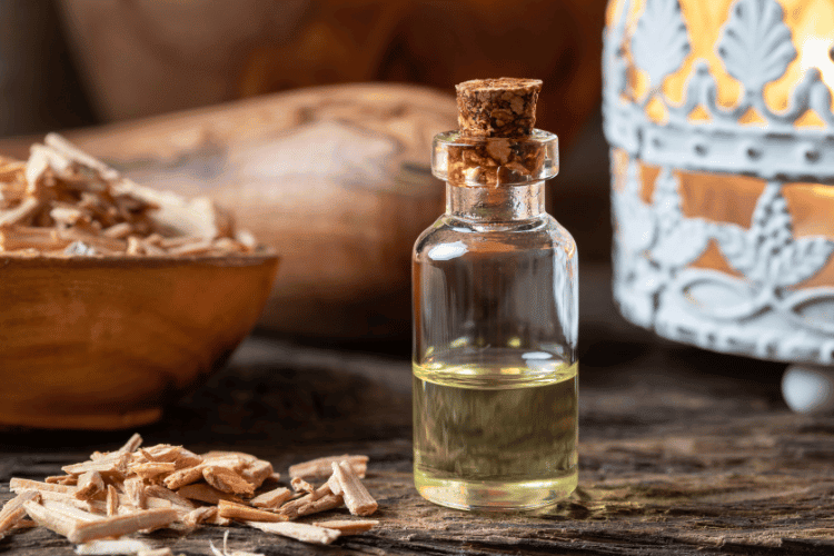 A bottle of cedar essential oil with cedar wood