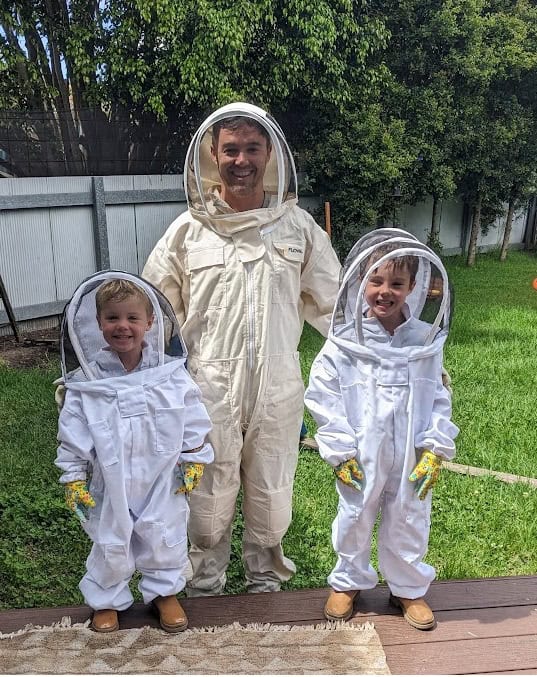 Matt Flood and his children suited up and ready to inspect the rooftop beehives
